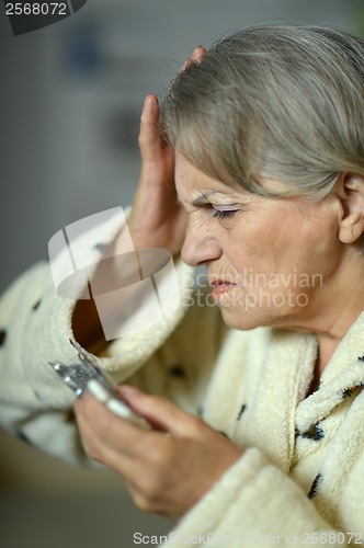 Image of Senior  woman with pills