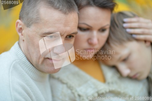 Image of Sad family of three on the nature