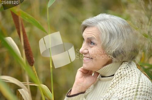 Image of Smiling senior woman in autumn