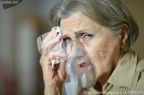 Image of Elderly woman making inhalation