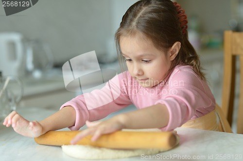 Image of Little girl kneading dough