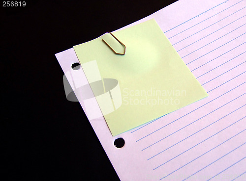 Image of Clipped yellow paper on lined paper background