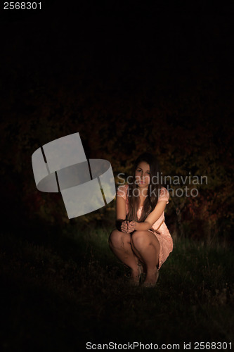 Image of Sad young woman at night