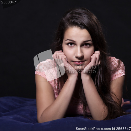 Image of Young woman in pink mini dress