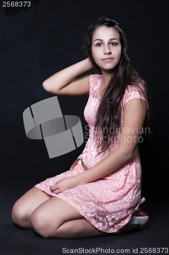 Image of Young woman in pink mini dress