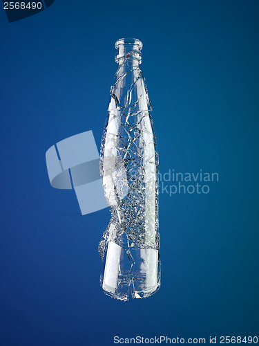 Image of Broken empty glass bottle over blue