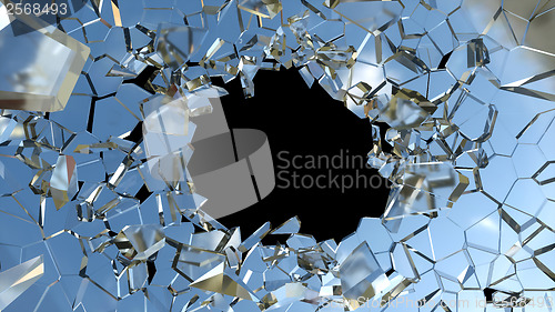 Image of Bullet hole and pieces of shattered blue glass 