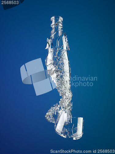 Image of Pieces of shattered empty bottle on blue