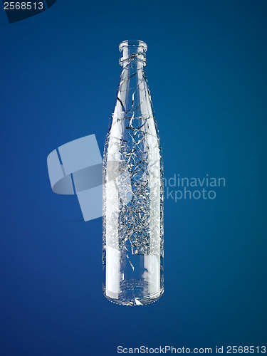 Image of Shattered empty glass bottle over blue