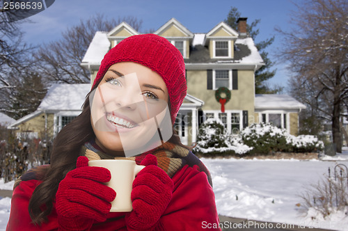 Image of Smiling Woman in Winter Clothing Holding Mug Outside in Snow