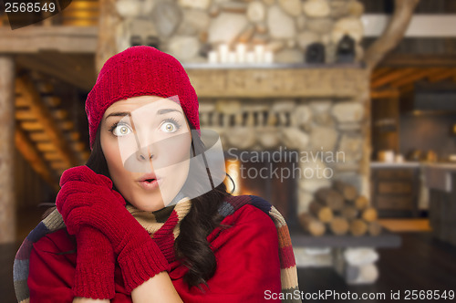Image of Mixed Race Girl Enjoying Warm Fireplace In Rustic Cabin