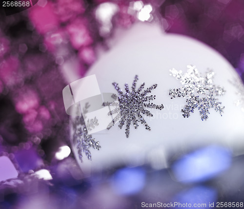 Image of white Christmas bauble with metallic ornaments