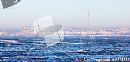Image of city ??by sea with Russian winter ice and snow