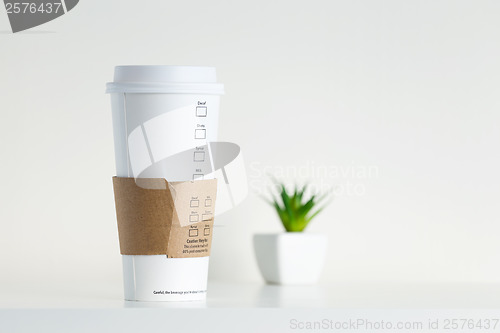Image of White Paper Cup and green potted plant
