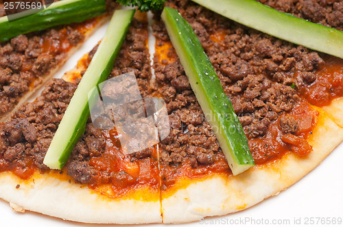 Image of Turkish beef pizza with cucumber on top