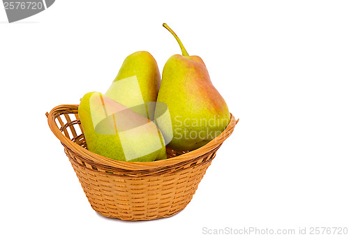 Image of Large ripe pears in a wicker basket on a white background.