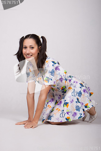 Image of A girl with pigtails in colorful retro dress