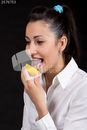 Image of woman eat yellow lemon