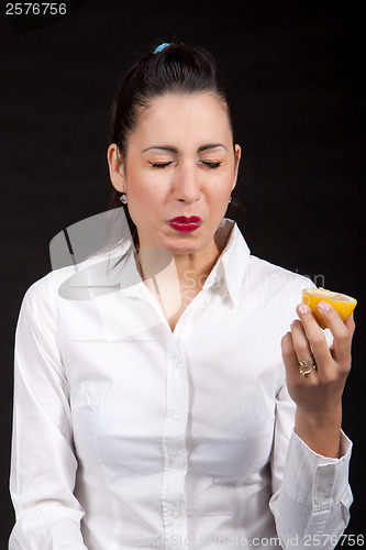 Image of woman eat yellow lemon