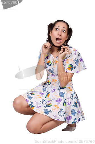 Image of A girl with pigtails in colorful retro dress