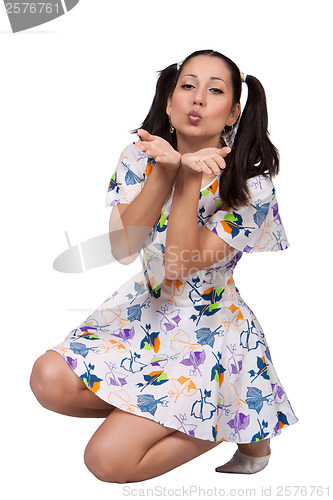 Image of A girl with pigtails in colorful retro dress