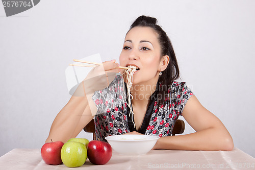 Image of Woman eat noodles