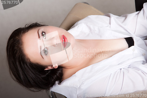 Image of Portrait of long-haired woman in a white men's shirt
