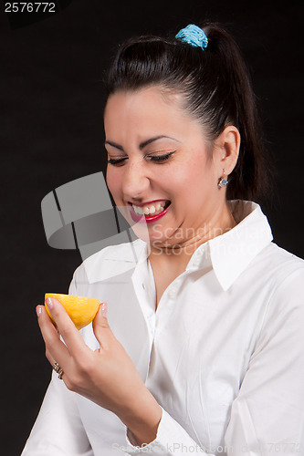 Image of woman eat yellow lemon