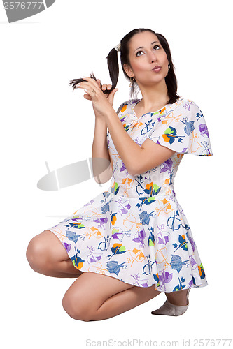 Image of A girl with pigtails in colorful retro dress