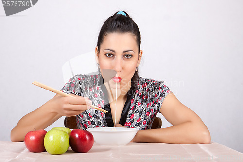 Image of Woman eat noodles