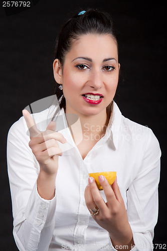 Image of woman eat yellow lemon