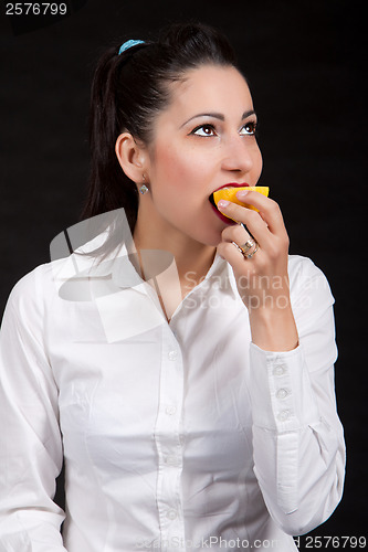 Image of woman eat yellow lemon