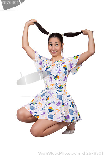 Image of A girl with pigtails in colorful retro dress