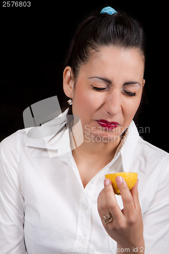 Image of woman eat yellow lemon