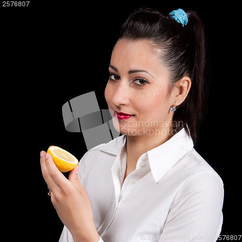 Image of woman eat yellow lemon