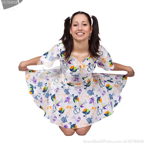 Image of A girl with pigtails in colorful retro dress