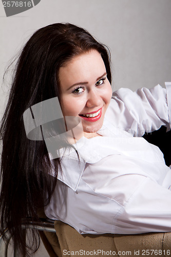 Image of Portrait of long-haired woman in a white men's shirt