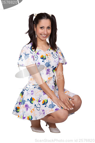 Image of A girl with pigtails in colorful retro dress