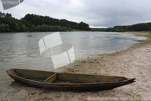 Image of landscape with river and boat in the evening