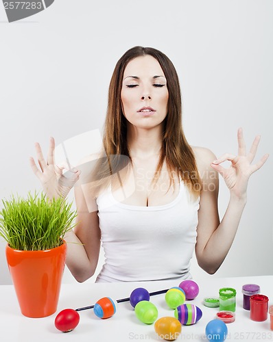 Image of Relaxed girl and painted eggs