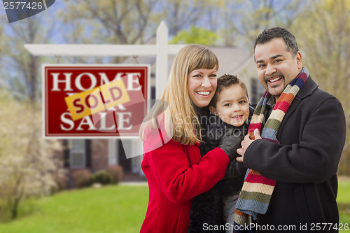 Image of Family in Front of Sold Real Estate Sign and House