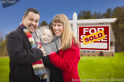 Image of Family in Front of Sold Real Estate Sign and House