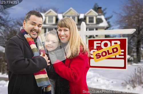 Image of Family in Front of Sold Real Estate Sign and House