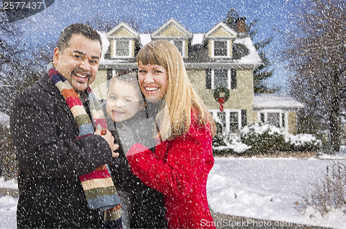 Image of Mixed Race Family in Front of House in The Snow