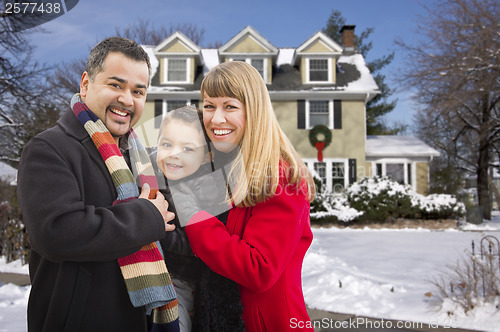 Image of Mixed Race Family in Front of House in The Snow