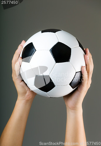 Image of Hand holding soccer ball