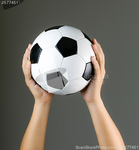 Image of Hand holding soccer ball