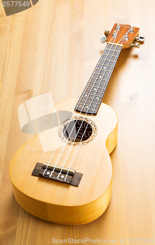 Image of Ukulele on wood background 