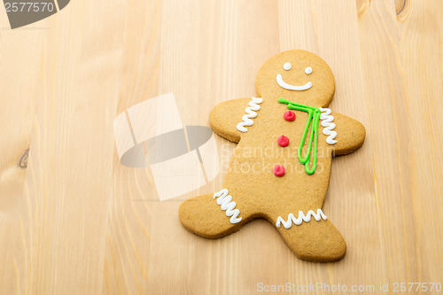 Image of Gingerbread man over the wooden background