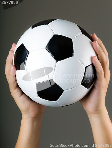 Image of Hand holding soccer ball